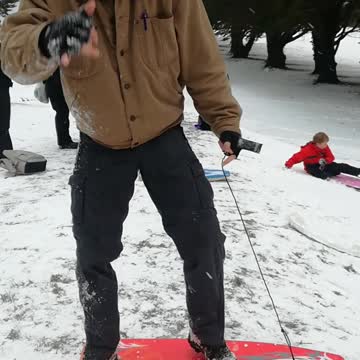 Music man boogie boards down snowy hill falls