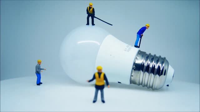 Close-up View Of A Lightbulb And Miniature Toys