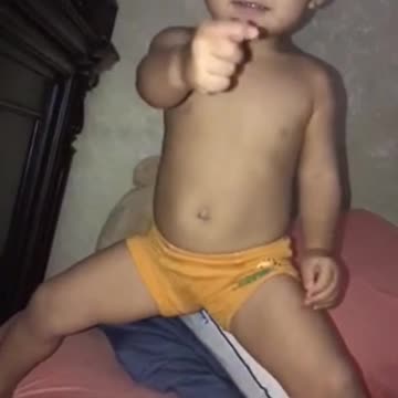 Cute baby is copying mom to practice martial art