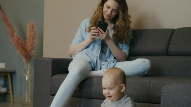 mom and her baby playing with ball