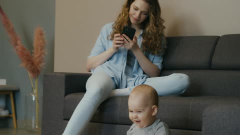 mom and her baby playing with ball