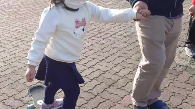 Cute baby riding a skateboard.