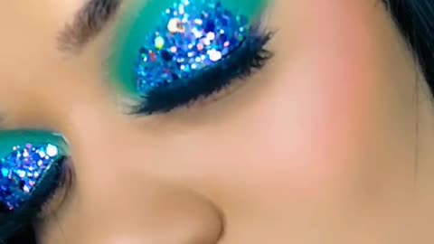 green makeup with purple glitter