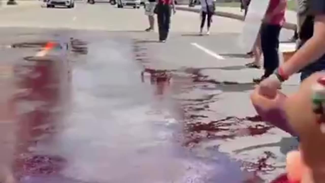 Pro-Palestine protestors pour fake blood on the streets outside AIPAC headquarters in DC.