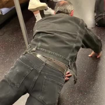 Old man in grey denim doing one hand push ups