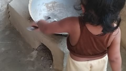 Trijal Babu making food for cattle