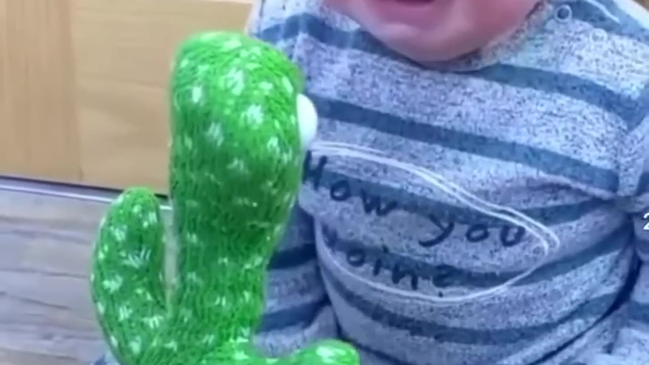 Cute babies paying with dancing cactus