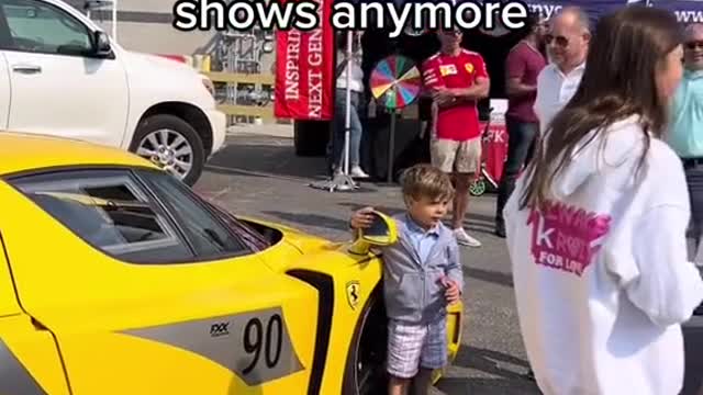 Kids who are very interested in the cars on display