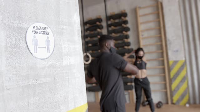 A Social Distancing Sign on a Wall at a Gym