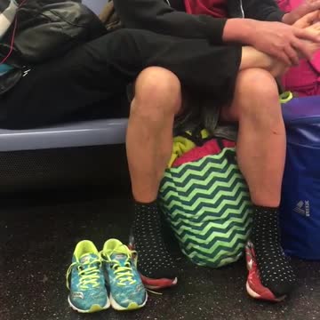 Man in red shirt and black jacket giving woman foot massage
