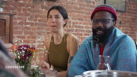 Two friends smiling and laughing at dining table