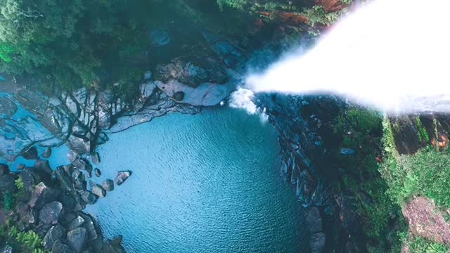 The bottom of a giant deep pit, with waterfalls cascading down