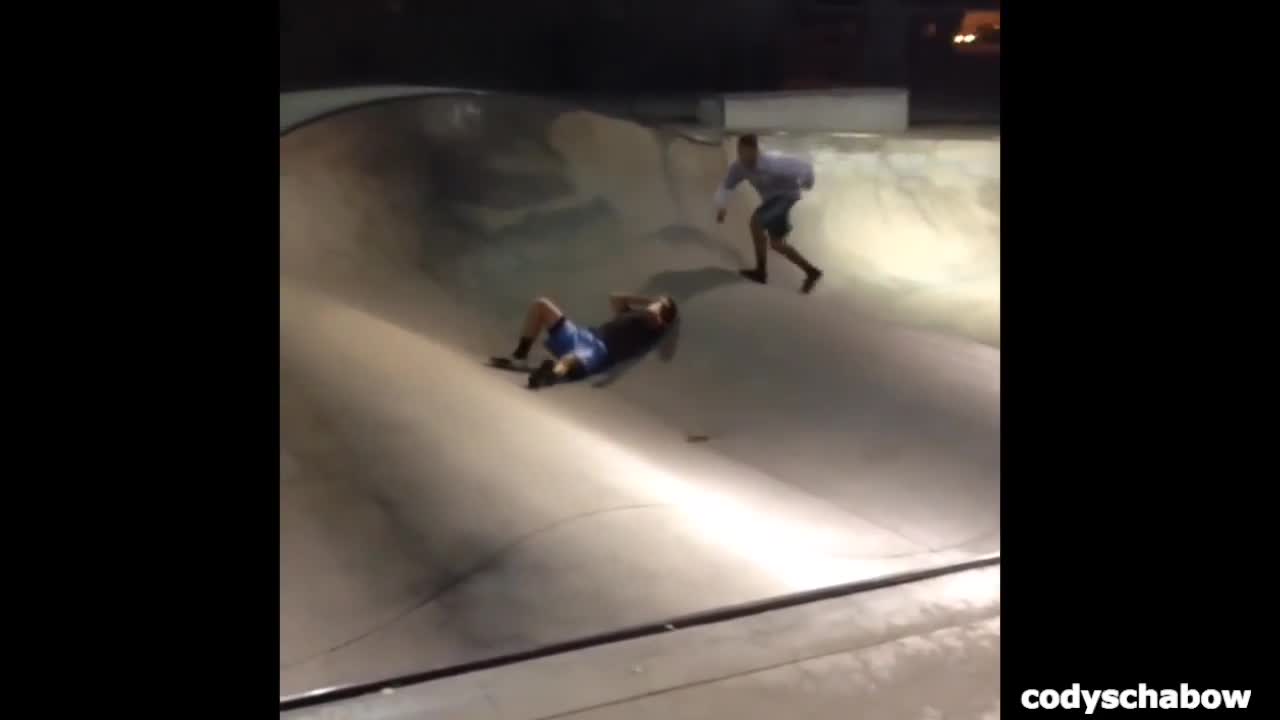 Teen brown shirt blue skatepark