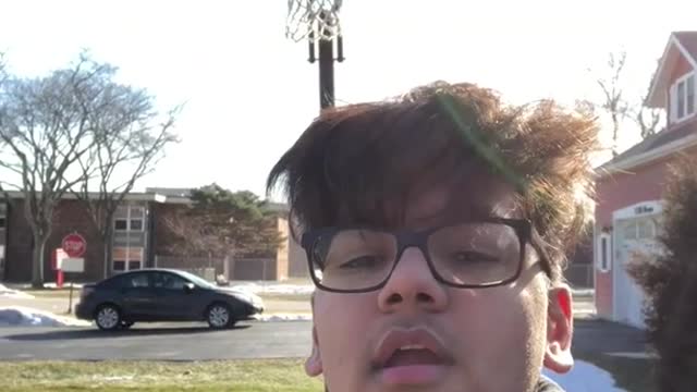 Boy records himself shooting basketball behind his back, ball hits his head