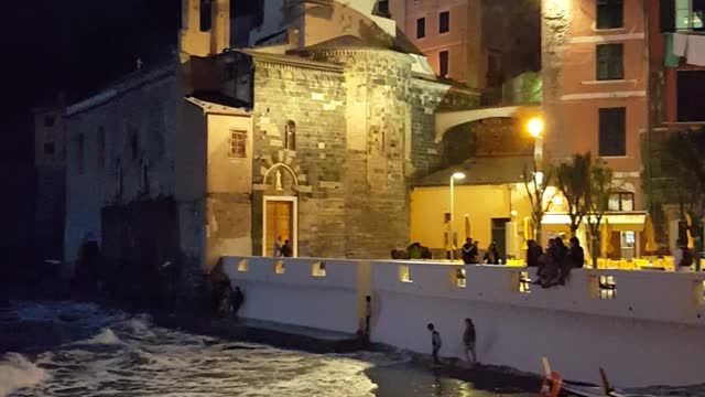 Kids playing at the waters edge in Vernazza, Italy