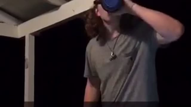 Guy breaks glass beer can with head