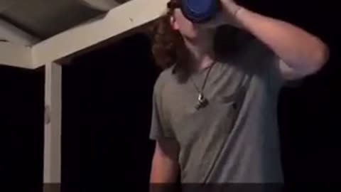 Guy breaks glass beer can with head