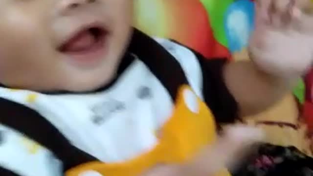 baby is very happy and laughs while playing with his mother