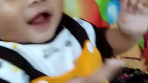 baby is very happy and laughs while playing with his mother