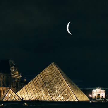 Great fireworks over pyramids with moon showing