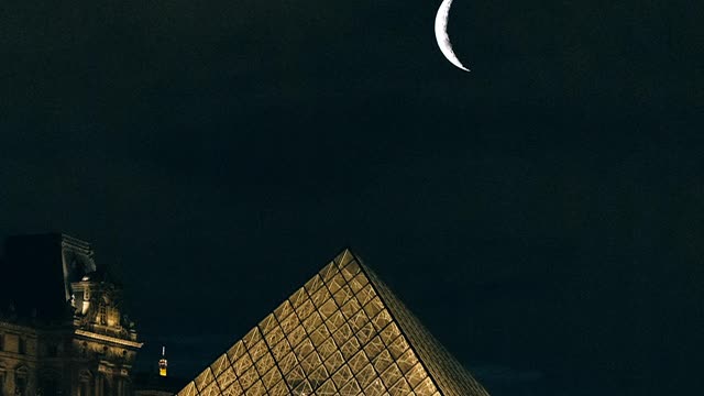 Great fireworks over pyramids with moon showing