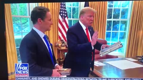 Trump shows the photo of JFK Jr playing under the desk