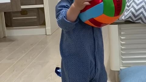 Cute adorable baby playing with ball