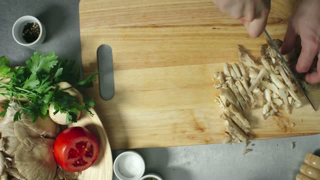 A Person Slicing Mushrooms