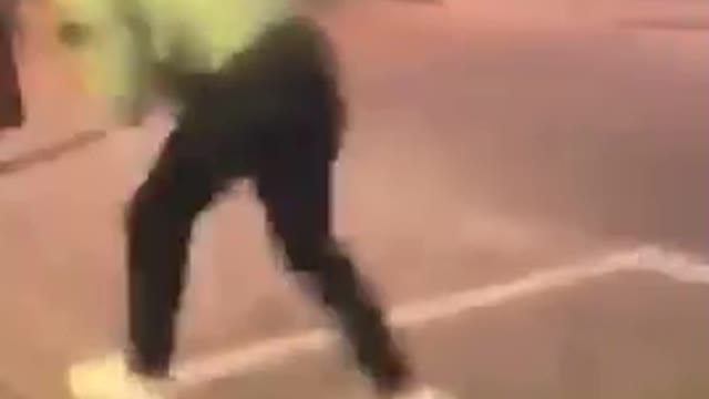 Guy in gray sweater runs into yellow sign