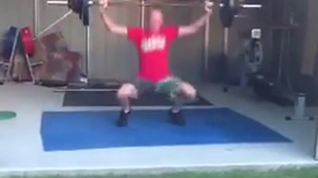 Guy red shirt weights falls on his back garage