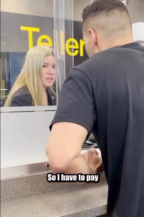 Man attempts to withdraw cash from the bank.