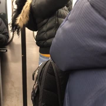 Woman in black jacket fixes hair weave piece