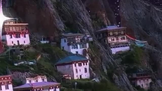 moonlight with houses cradled in the rock