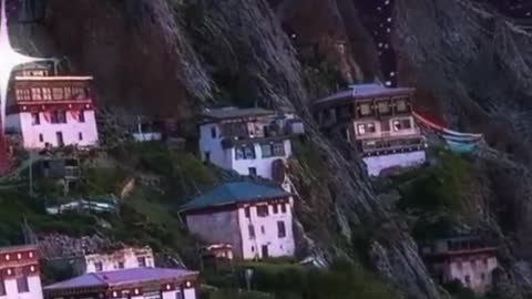 moonlight with houses cradled in the rock