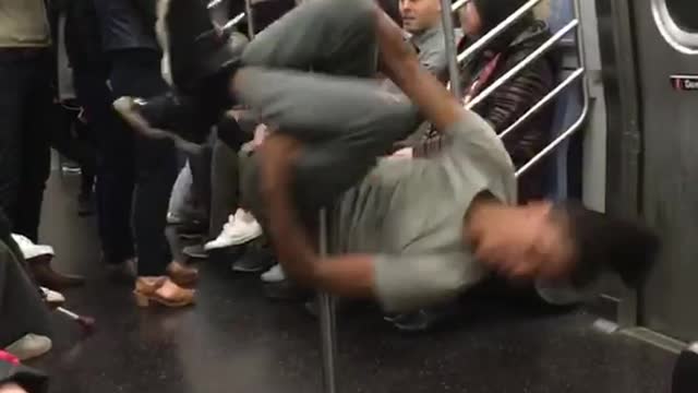 Guy grey dancing spinning subway pole