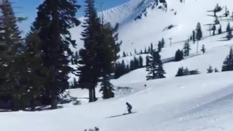 Two guys pink and green skis jump