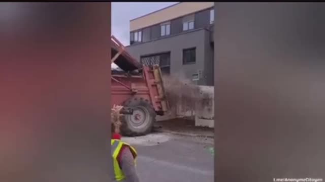 French farmers drop manure front of a taxation center, gas stations and other government buildings.