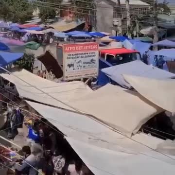 Spraying disinfection on people in fhe market