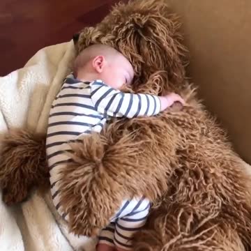 He's hugging the baby.