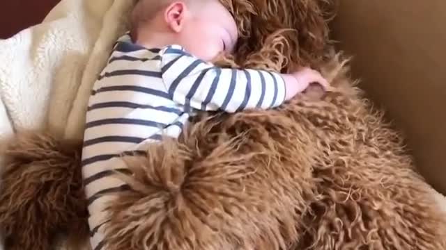 He's hugging the baby.