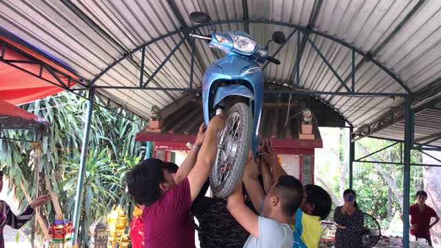 Dancing Lady Balances Bike on Her Head