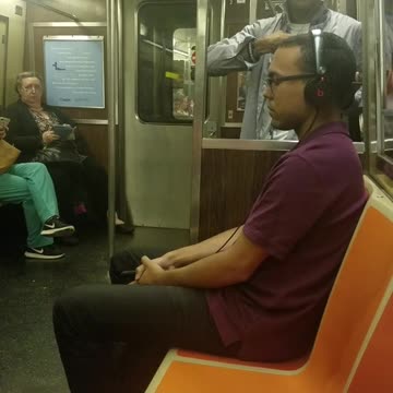 Man with glasses blue shirt singing dancing