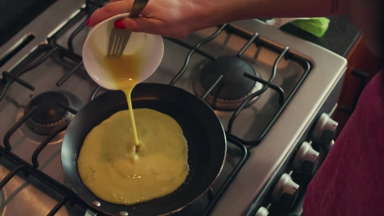 Woman serving eggs in a pan for breakfast