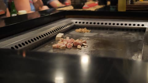 Chef cooking on a large grill