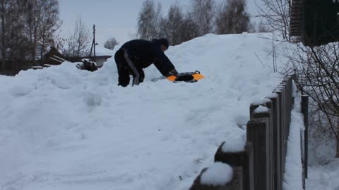 dad and daughter try to roll down the hill