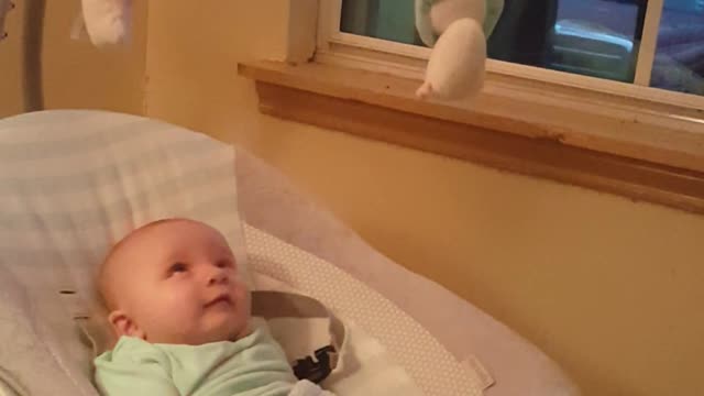 Adorable baby cooing and talking to his reflection