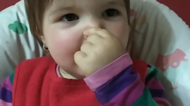 Girl cracking up to hear the sounds she can make