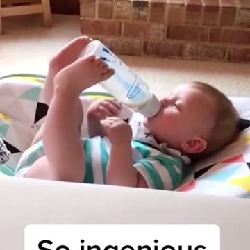 TODLER HOLDING HIS BOTTLE BY TWO LEGS.mp4