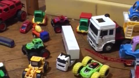 The girl loves to play with cars.
