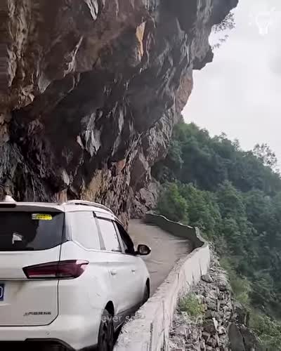 Driving in a narrow rocky mountain road